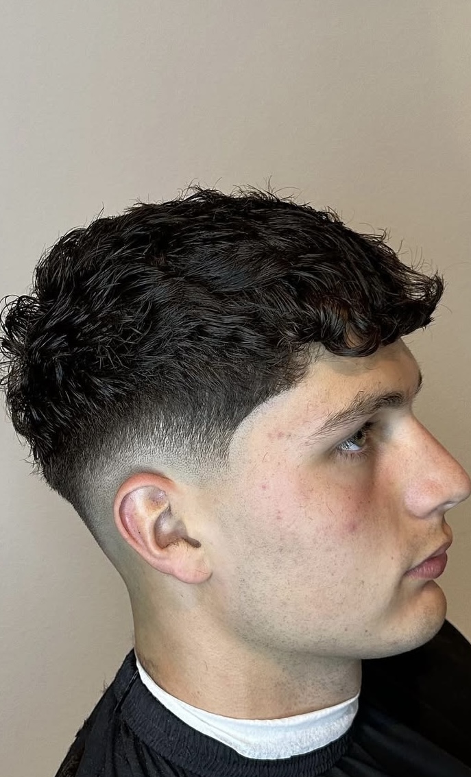 Textured curly top with low taper fade by Javistylz